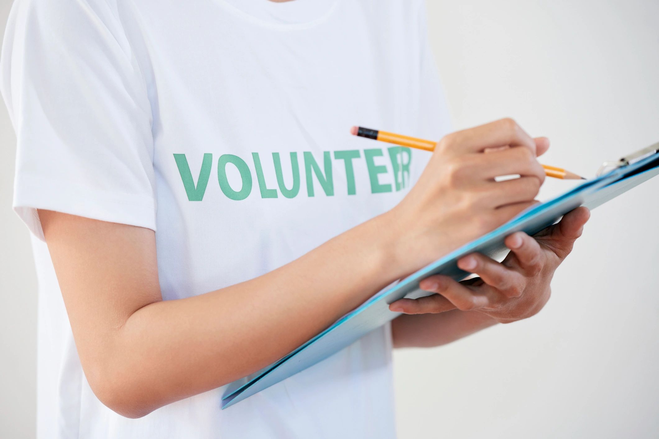 Volunteer holding a clipboard and taking notes
